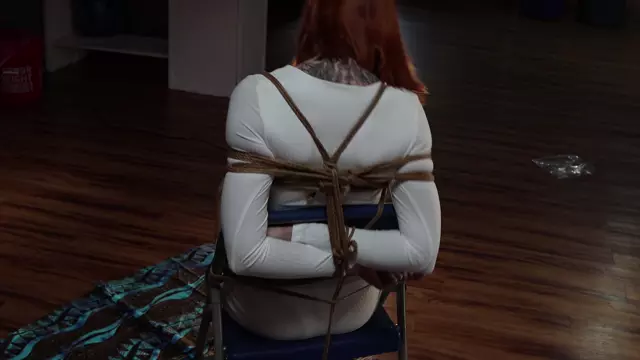 Poster: Kimberly Jay all dressed in white gets tied to a chair and gagged